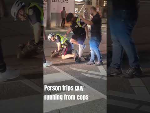 Person trips guy trying to run away from the cops.