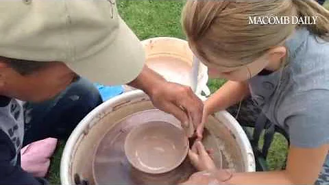 Pottery artist Jack Leyrer shows Olivia Braun how ...