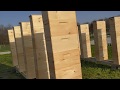 Quickly painting honey bee hive boxes with a power sprayer.