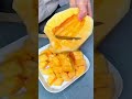 cutting a ripe sweet melon into small bite sized pieces on a white plate for a healthy fruit snack