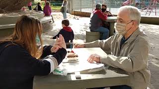Family sings happy birthday at the park then little boy attempts to climb table and bumps chin