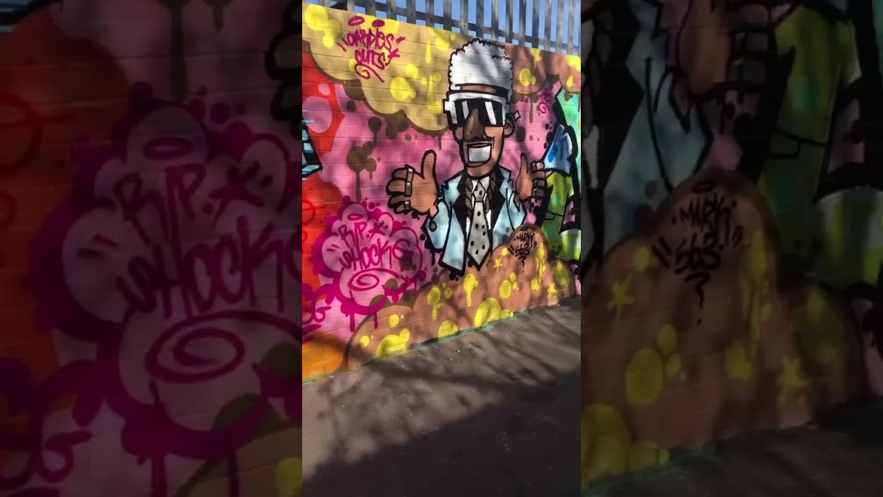 London Graffiti on runner train in traffic 