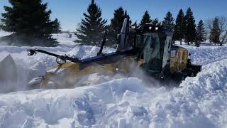 Cat 140M2 working deep snow with Falls V plow