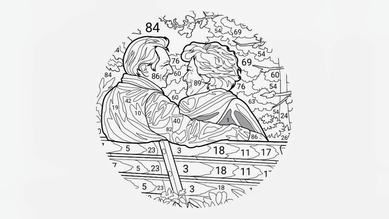 An elderly couple seated on a park bench facing each other and smiling warmly. 