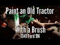 Painting an old tractor with a paint brush, a 1941 Ford 9N