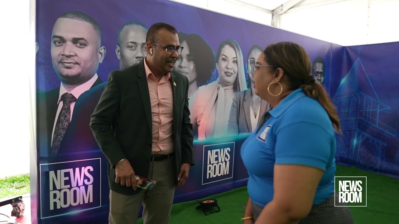 FOREIGN SECRETARY ROBERT PERSAUD VISITS THE NEWS ROOM'S BOOTH AT THE ARTHUR CHUNG CONFERENCE CENTRE.