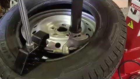 Demonstrating Bright PL230 assist arm fitted to Bright LC810 tyre changer