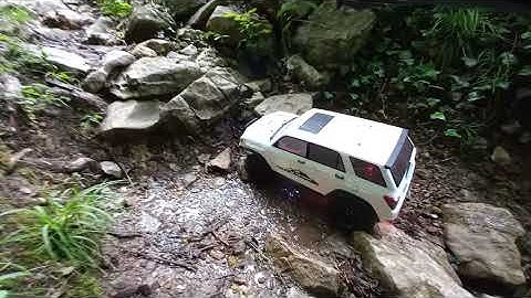 Element RC Upgraded Trailrunner in a wet rocky canyon.