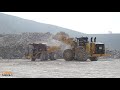 Caterpillar 990K loading shovel and Komatsu HD605 and Cat quarry trucks.
