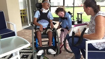 Angela talking to Siah using PODD with partner assisted scanning