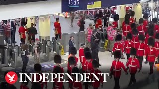 Live: Soldiers taking part in the coronation arrive at Waterloo station