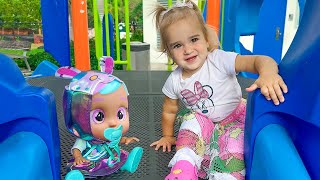 Alice plays Hide and Seek with her dolls on the playground