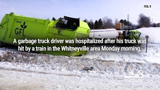 Driver hospitalized after garbage truck hit by train near Whitneyville