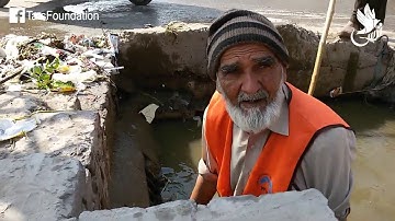 TARS Foundation | An Old Man Cleaning a Dirty Drain in Peshawar