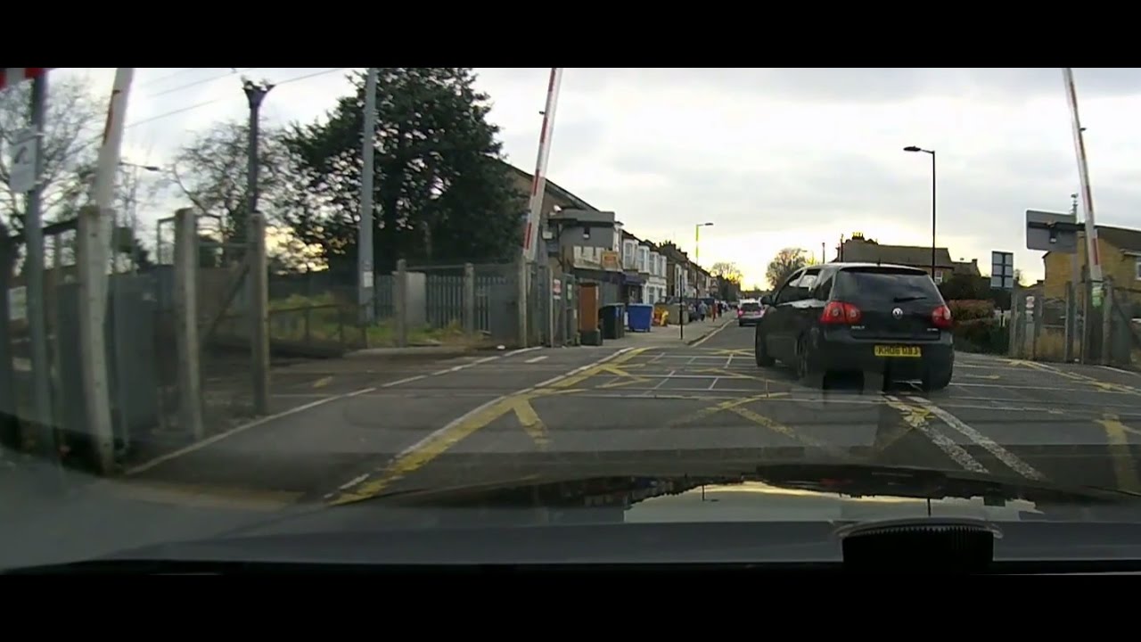Enfield Lock, VW Driver goes through, red flashing level crossing barriers, nearly hitting them.