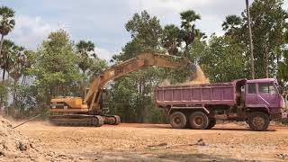 Dump Truck And CAT 320 Excavator At Work