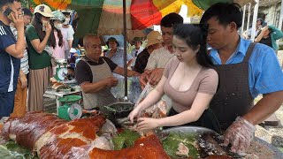 Girl selling roasted pig at ethnic minority festival people lined up to buy