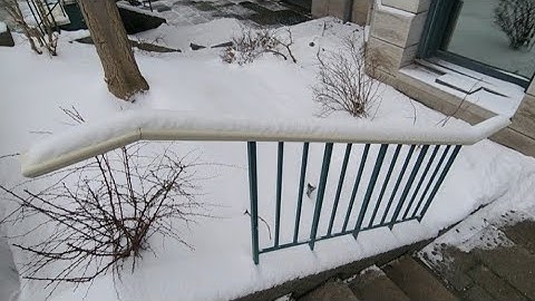 Removing Snow From Exterior Basement Staircase Handrail