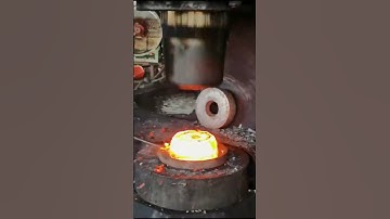 Forging high-temperature rectangular iron blocks into circular iron cakes before drilling