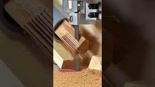 cutting the edge of thin wooden strips with a sharp metal band saw machine very neatly and precisely