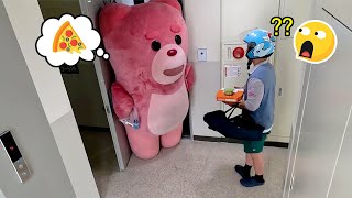 Giant Pink Bear Paying for Pizza Delivery