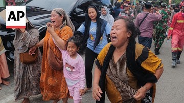 Rescuers work to free survivors after Indonesia school building collapse