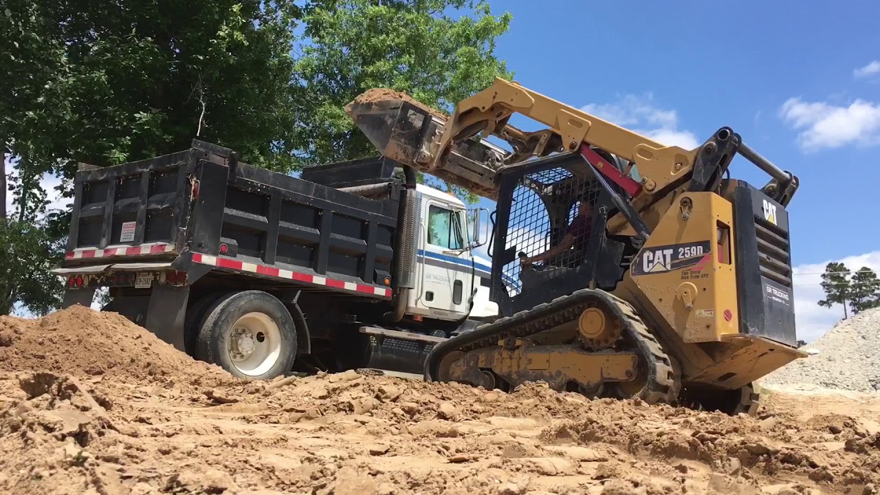 Caterpillar 259D skid steer loading dump truck with dirt YouTube