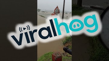 Excavator Returning to Shore Wades Against Floodwaters || ViralHog