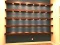 Build wall-to-wall shelves with recessed lights