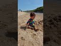 Naby playing in the sand at holywell bay toddler