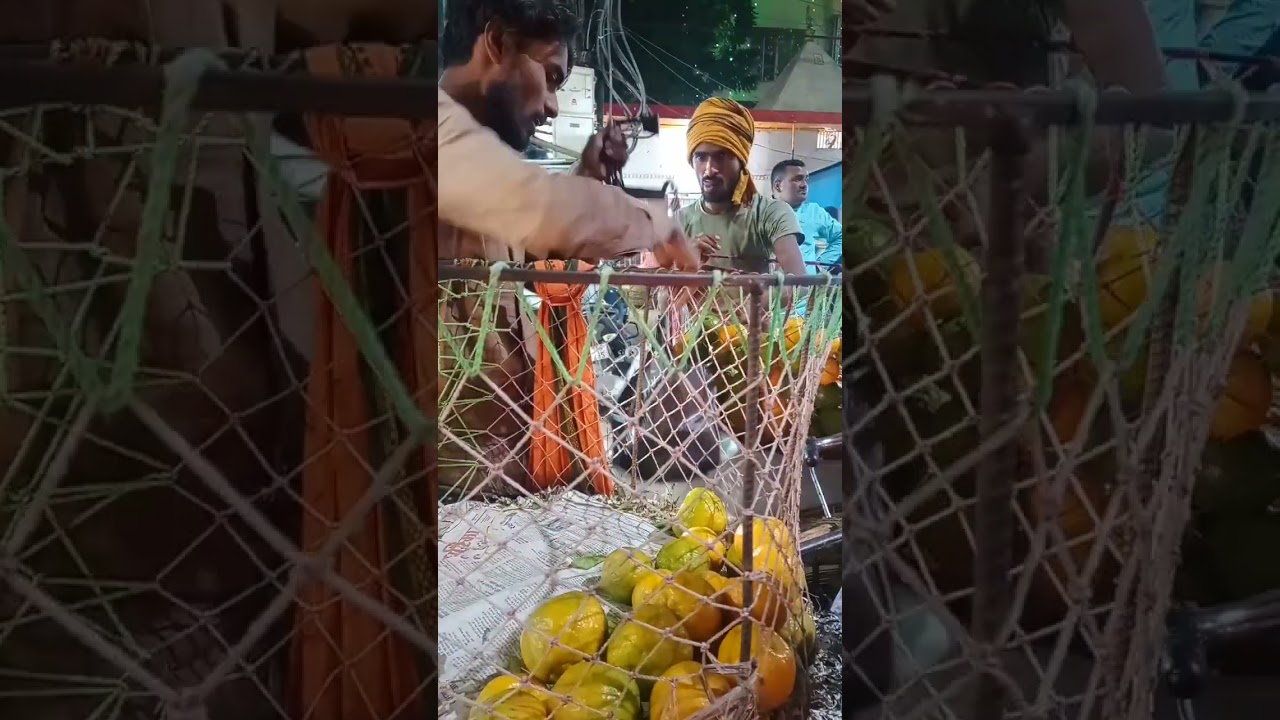 hardworking man selling fruits on street on his cycle