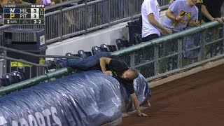 MIL@PIT: Fan retrieves foul ball, tosses to young fan