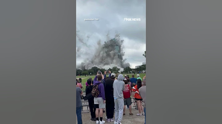 Spectators watch controlled building implosion in Louisiana
