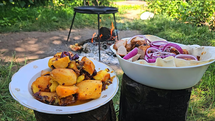 Cooking meat and potatoes over an open fire