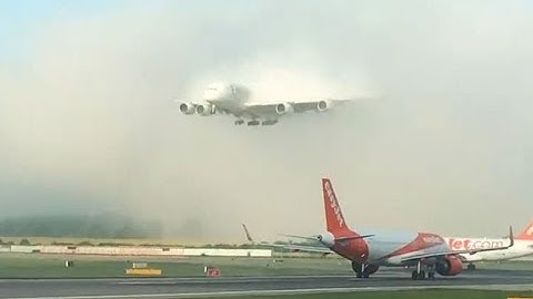 Emirates A380 Landing Through Clouds Over Wings