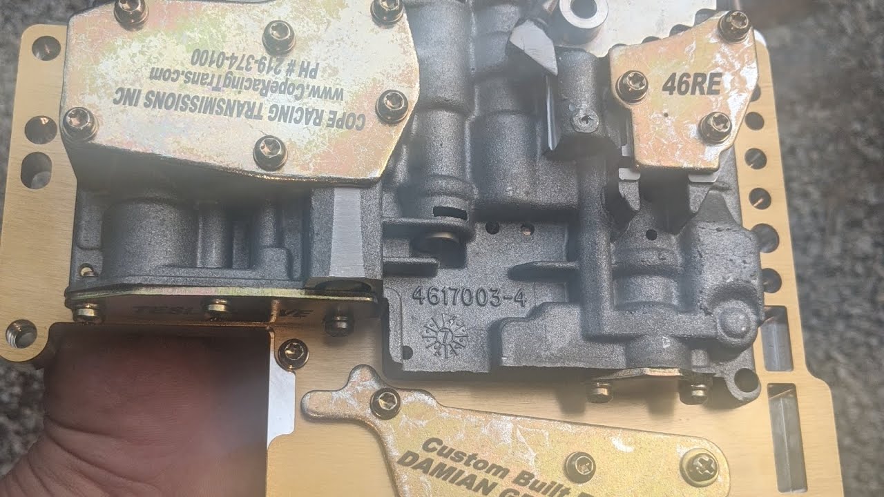 46RE, Reverse Pattern Manual Valve body. Lowering the filter to submerge the filter in the pan