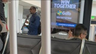 Andre 3000 spotted playing flute at Los Angeles airport