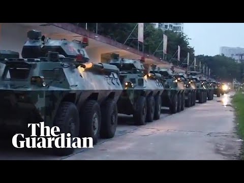 China releases video showing troop carriers moving to Hong Kong border