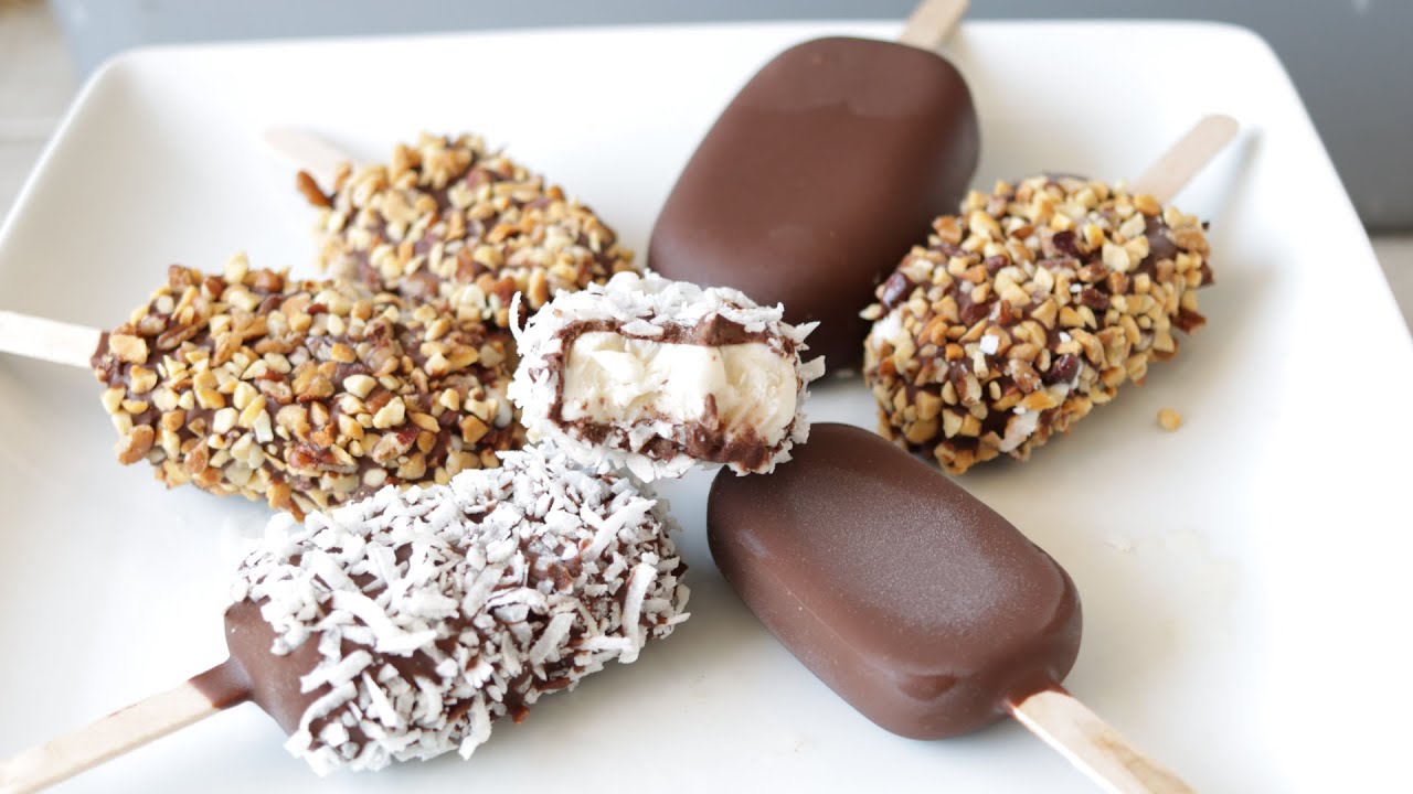 Tasty Homemade Ice Creams Pop With Sticks In Containers On Grey