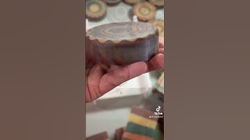 Cleaning the sharp edge of a round kaleidoscope soap bar with a soap router tool.