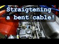 Straightening a bent push/ pull cable and installation