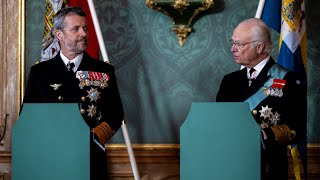 King Carl Gustaf of Sweden jokes with King Frederik of Denmark