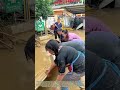 Combining Strength: Community Volunteers Clear Flood Mud From Residential Courtyards