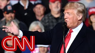 Trump debuts new slogan and conspiracy theory