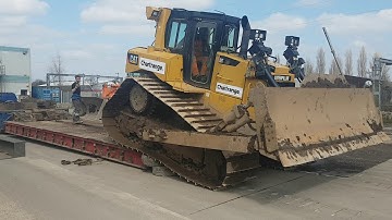 Caterpillar D6T bull dozer machine loading on to low bed low loader transporter