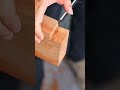 cutting and shaving precise wooden joints with sharp chisels to build high quality wooden furniture