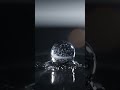 Ice crystal slowly melts into a perfect, light-refracting water droplet.