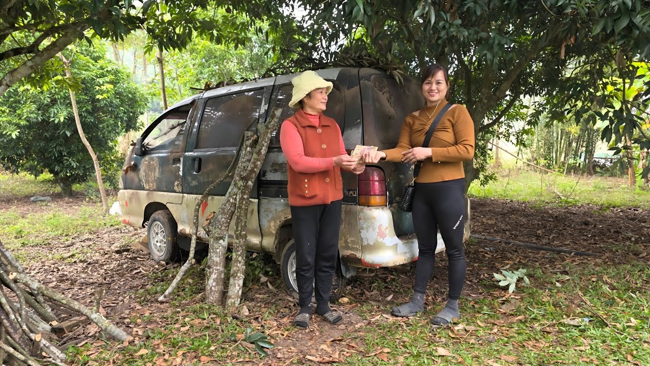 Girl repairs and restores engines of old cars.