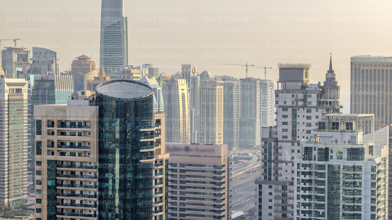 Aerial top view of Dubai Marina morning timelapse. Modern towers and traffic on the road