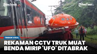 CCTV footage shows the moment a truck carrying a UFO-like object was hit by a train.